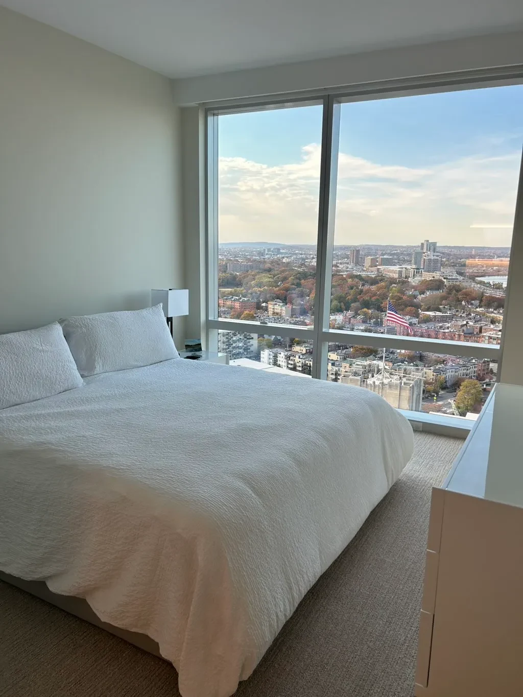 Clean bright bedroom with city view